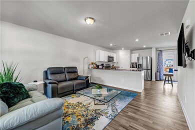 Living room featuring baseboards, wood finished fl