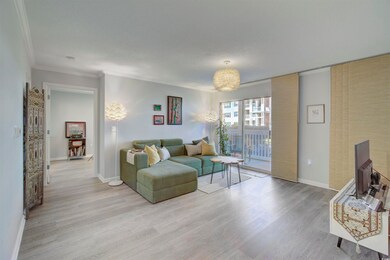 Living room with ornamental molding and light hard