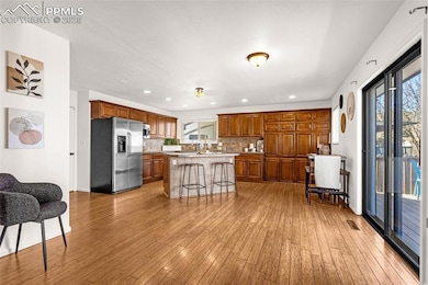Kitchen featuring brown cabinets, a kitchen island