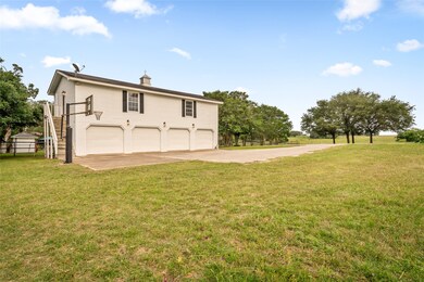 The detached 4-car garage offers ample storage and