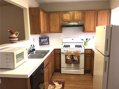 Kitchen with white appliances, light countertops,