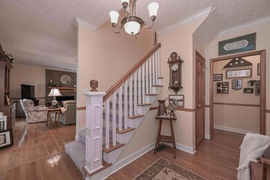 FOYER IS OPEN AND YOU WILL NOTICE RIGHT AWAY THE CHAIR RAILING, CROWN MOLDING AND HARDWOOD FLOORS THAT CONTINUE THROUGHOUT THE MAIN LEVEL.