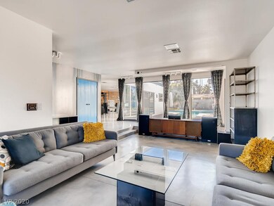 Large living room with concrete floors & windows t