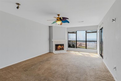Unfurnished living room with ceiling fan, a tiled 