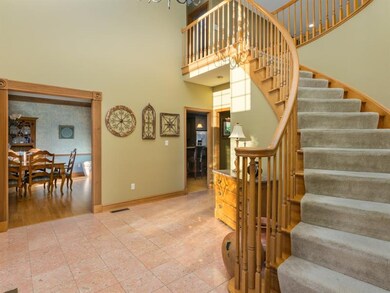 The large, bright foyer with the sweeping staircas