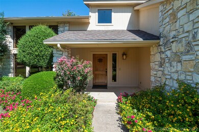 Inviting covered front porch & lush landscaping.