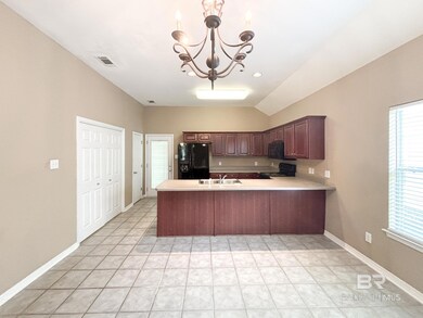 Kitchen with black appliances, light countertops, a chandelier, a sink, and a peninsula