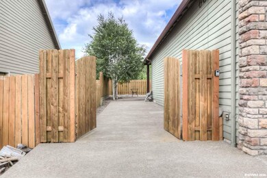 Exposed aggregate RV pad with privacy gate.