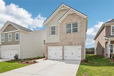 Craftsman inspired home featuring an attached garage, brick siding, concrete driveway, board and batten siding, and a front yard