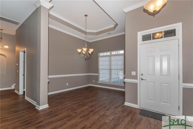 Entry way with hard wood floors.