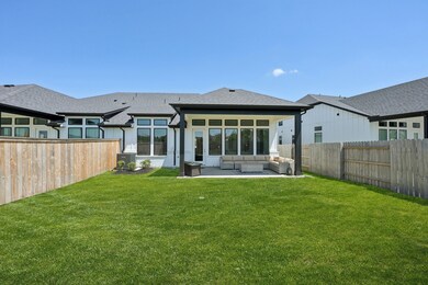 Covered back porch and plenty of green space.