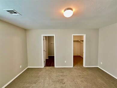 Unfurnished bedroom featuring a walk in closet, li