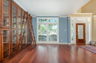 The formal living space has custom built-in cabinets with ladder, ideal for displaying your vast array of books, or special collections for all to see!