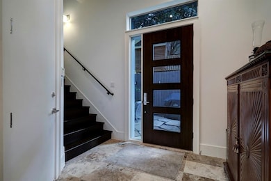 Inviting entryway welcomes you with high ceilings, neutral tones and modern tile flooring