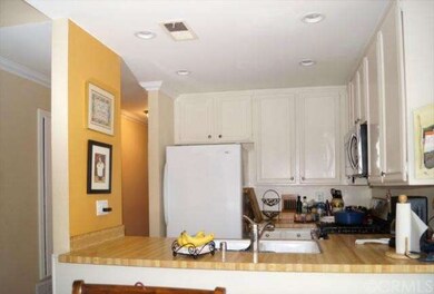 An efficient kitchen opens to the dining area.