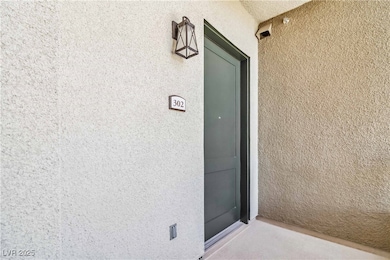 Unit Entrance to property featuring stucco siding