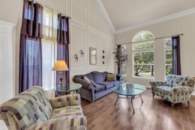 Living room with ornamental molding, a towering c