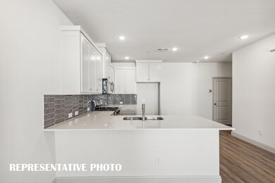 The kitchen peninsula, featuring a breakfast bar, 