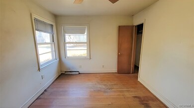 Spare room with ceiling fan and light hardwood / w