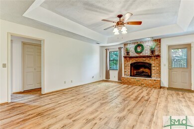 Great Room with tray ceiling and gas fireplace. Do