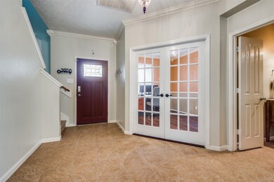 Looking at front door and office in front foyer & 1/2 bath on right