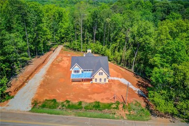 Birds eye view of property featuring a view of tre