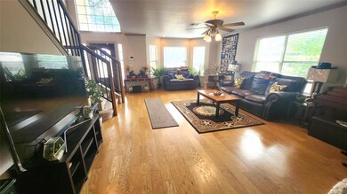 Living area with crown molding, ceiling fan, wood