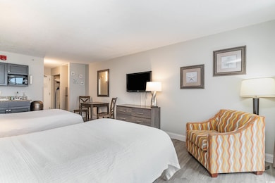 Bedroom featuring a sink, baseboards, and wood fin