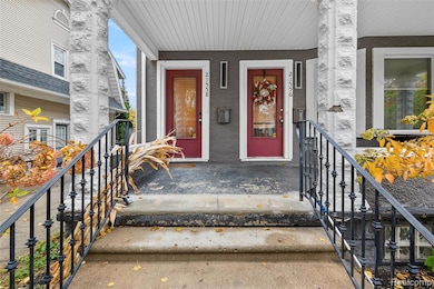 Entrance to property featuring covered porch and stucco siding