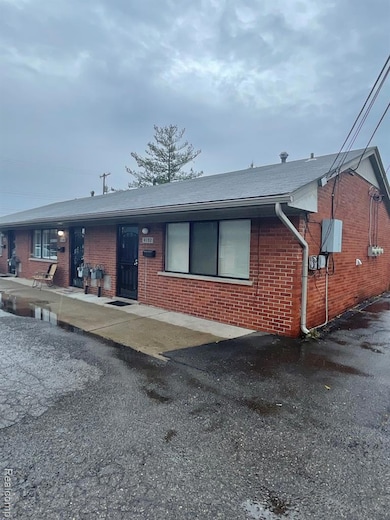 Ranch-style house featuring brick siding
