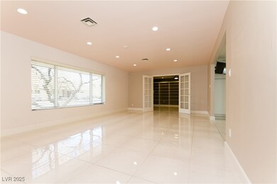 Spacious living room. At far end, entry to the den