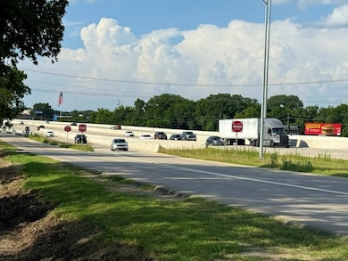 View of asphalt road with traffic signs