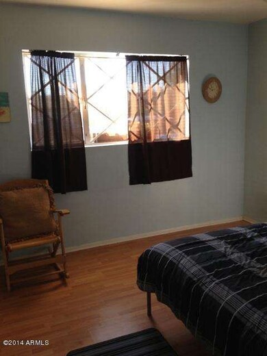2nd bedroom w/ faux wood flooring