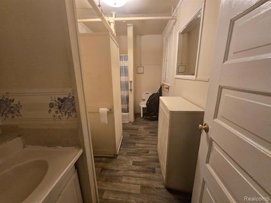 Full bath with a shower with curtain, dark wood-style flooring, a tub, and vanity