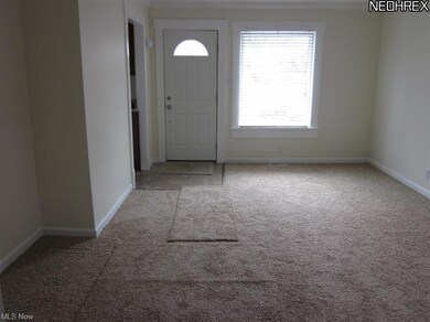 Front entryway into living room. Bright and neutral with new carpet and a large window