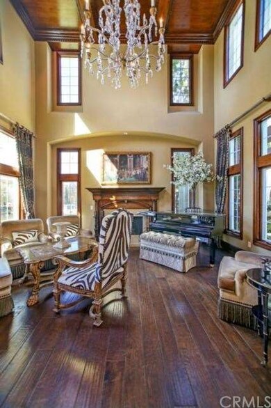 Living Room with hardwood flooring, custom coffere