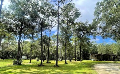 Temporary living quarters with circular driveway.  Mature oaks and pines.