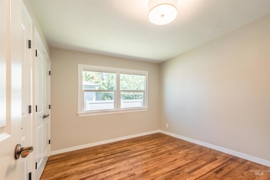 Empty room featuring light wood-style flooring and baseboards