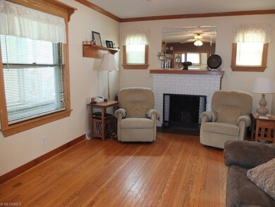 Living room with hardwood floor, crown molding and