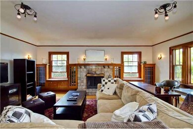 Living room with antique light fixtures, gumwood b