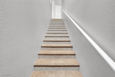 Staircase featuring a textured wall