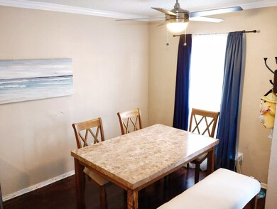 Dining room featuring ornamental molding, a textured ceiling, and ceiling fan