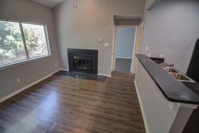 Living area with dark wood-style floors, a tiled 