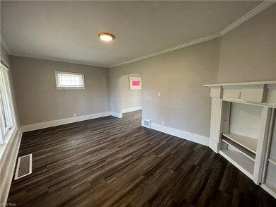 Hardwood floored living room with ornamental molding