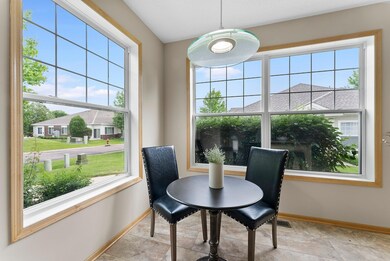 The informal dining room adjacent to the kitchen has large windows overlooking the front and side yards bringing in plenty of natural light.