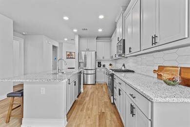 Kitchen with a sink, a kitchen bar, light wood-st