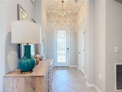 Entrance foyer with a notable chandelier and light