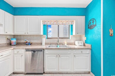 Kitchen with white cabinetry, sink, dishwasher, an