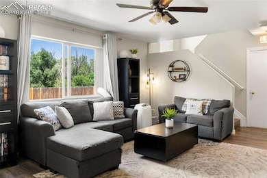 Living area featuring a ceiling fan and wood finished floors