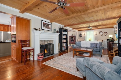 Rustic stone fireplace and warm wood ceiling with